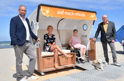 Barrierefreier Strandkorb in Warnemünde - Matthias Fromm (v.l.), Leiter der  Tourismuszentrale Rostock & Warnemünde, Birgit Hesse, Präsidentin des Landtages Mecklenburg-Vorpommern & Präsidentin des Tourismusverbandes  Mecklenburg-Vorpommern, Sylvi Tauber mit Hund Joe und Matthias Treichel, Inhaber der „Strandoase Treichel“