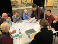 Bürgerbeteiligung in der Nordlichtschule Lichtenhagen, Tischgruppe hält Ideen auf einem Plan fest